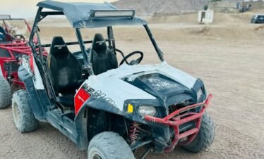 Tourists enjoying a 5-in-1 Safari Adventure in Sharm El Sheikh with buggy ride, Bedouin show, dinner, and stargazing. hasabotravel