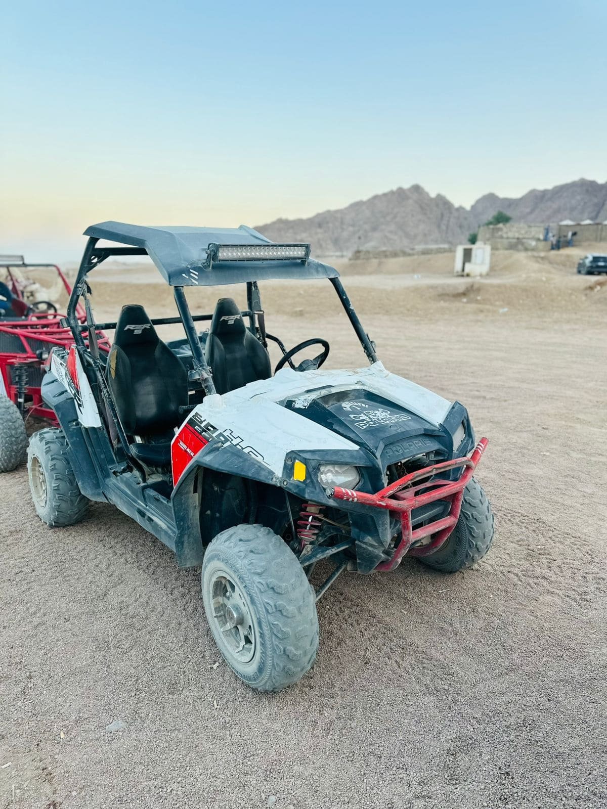 Tourists enjoying a 5-in-1 Safari Adventure in Sharm El Sheikh with buggy ride, Bedouin show, dinner, and stargazing. hasabotravel