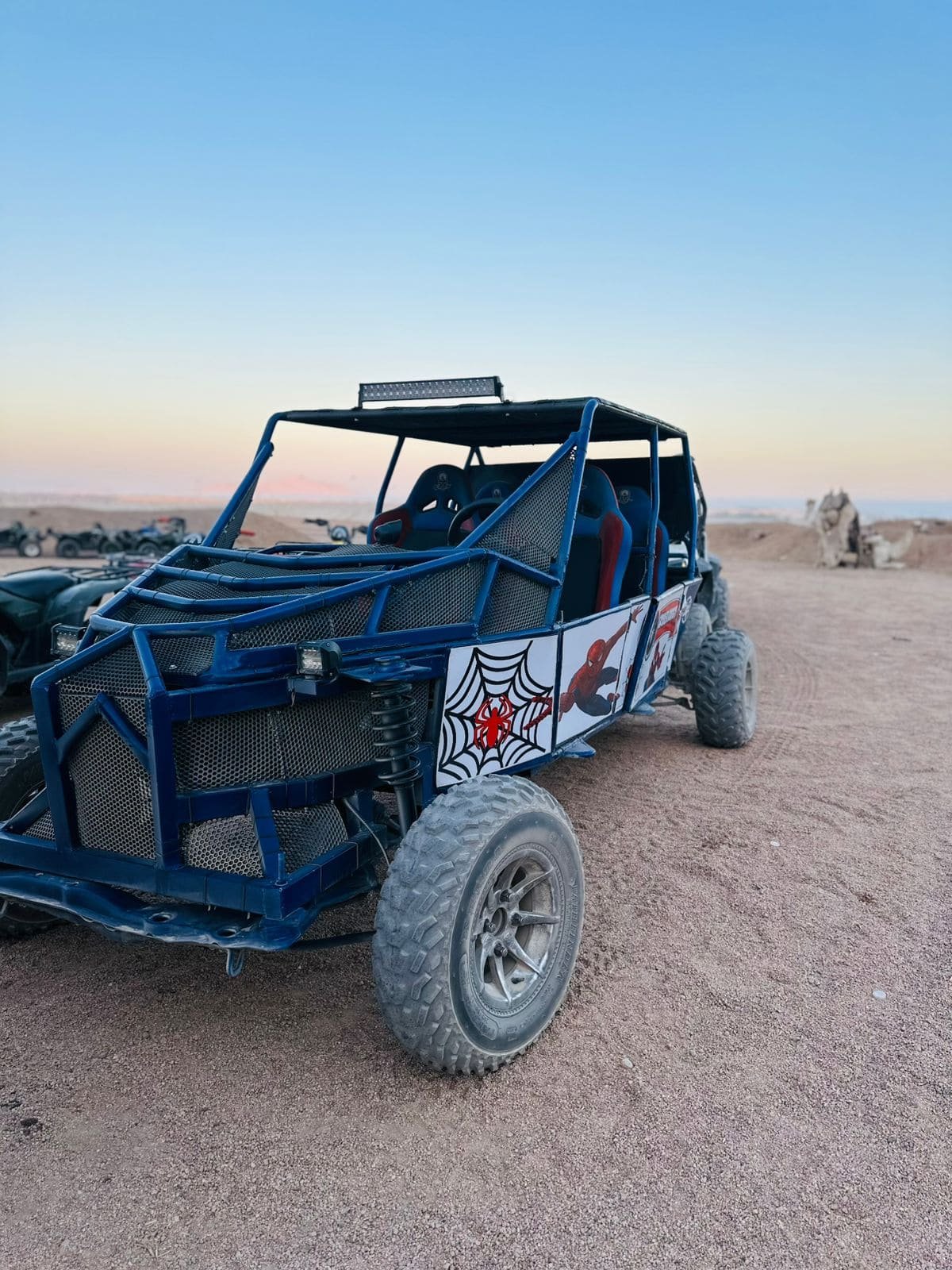 Tourists enjoying a 5-in-1 Safari Adventure in Sharm El Sheikh with buggy ride, Bedouin show, dinner, and stargazing. hasabo travel