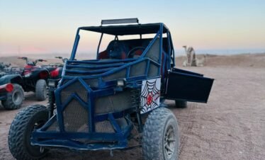 Tourists enjoying a 5-in-1 Safari Adventure in Sharm El Sheikh with buggy ride, Bedouin show, dinner, and stargazing. hasabo travel