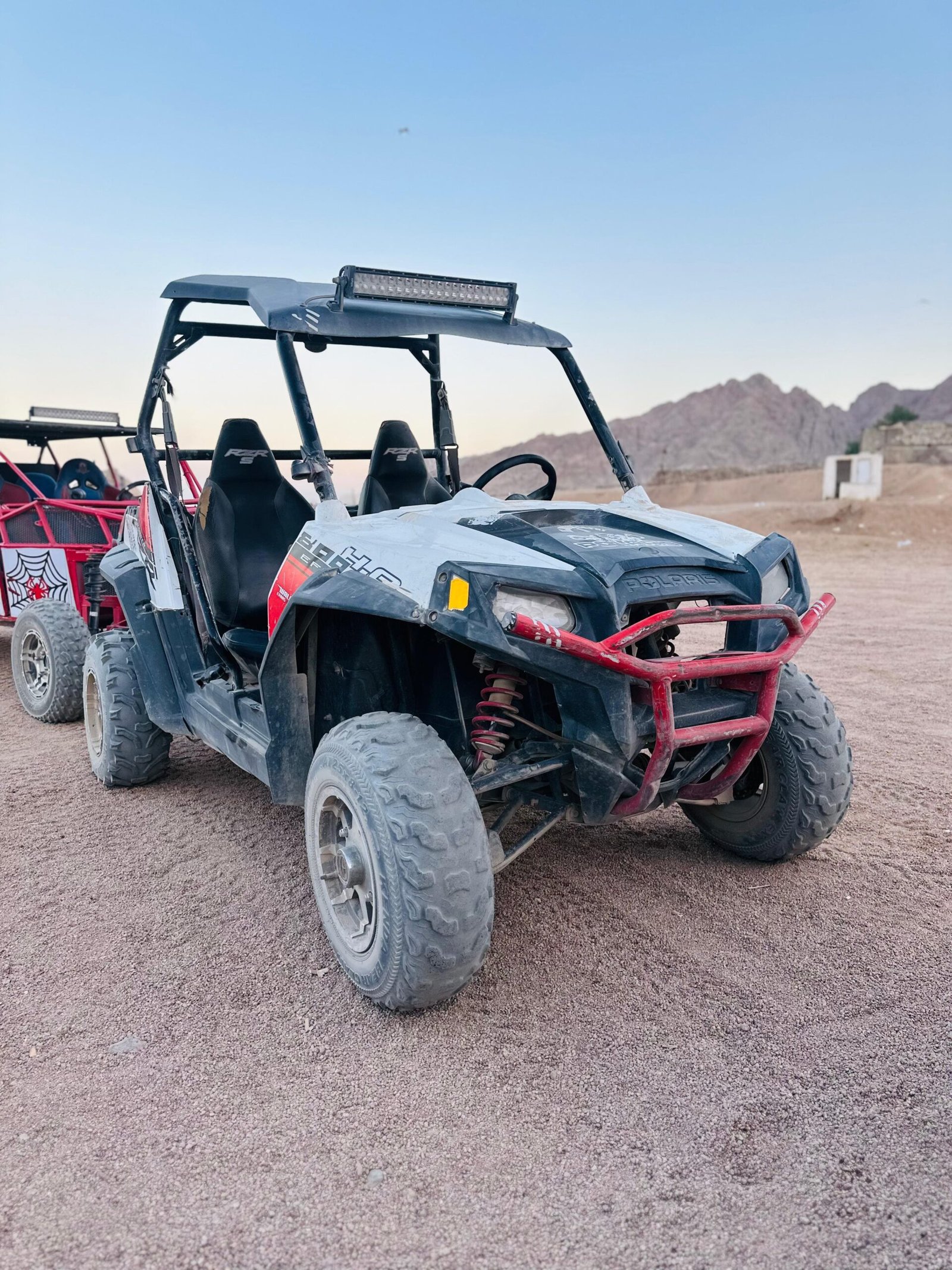 Tourists enjoying a 5-in-1 Safari Adventure in Sharm El Sheikh with buggy ride, Bedouin show, dinner, and stargazing. hasabo travel