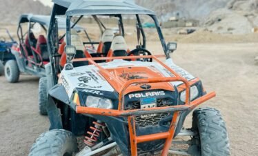 Tourists enjoying a 5-in-1 Safari Adventure in Sharm El Sheikh with buggy ride, Bedouin show, dinner, and stargazing. hasabo travel